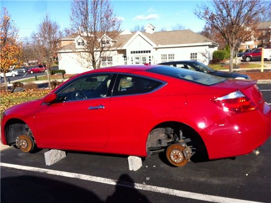 Red Car with Wheels and Tires Stolen